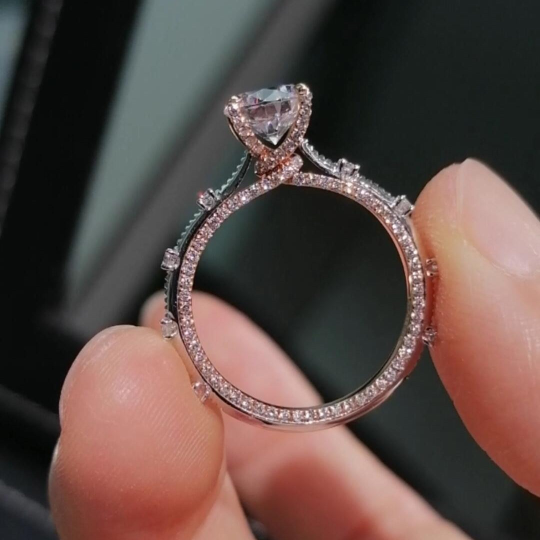 Two-tone band design with pavé-set diamonds; round lab-grown diamond in a four-prong setting, Color D, Clarity VS1.