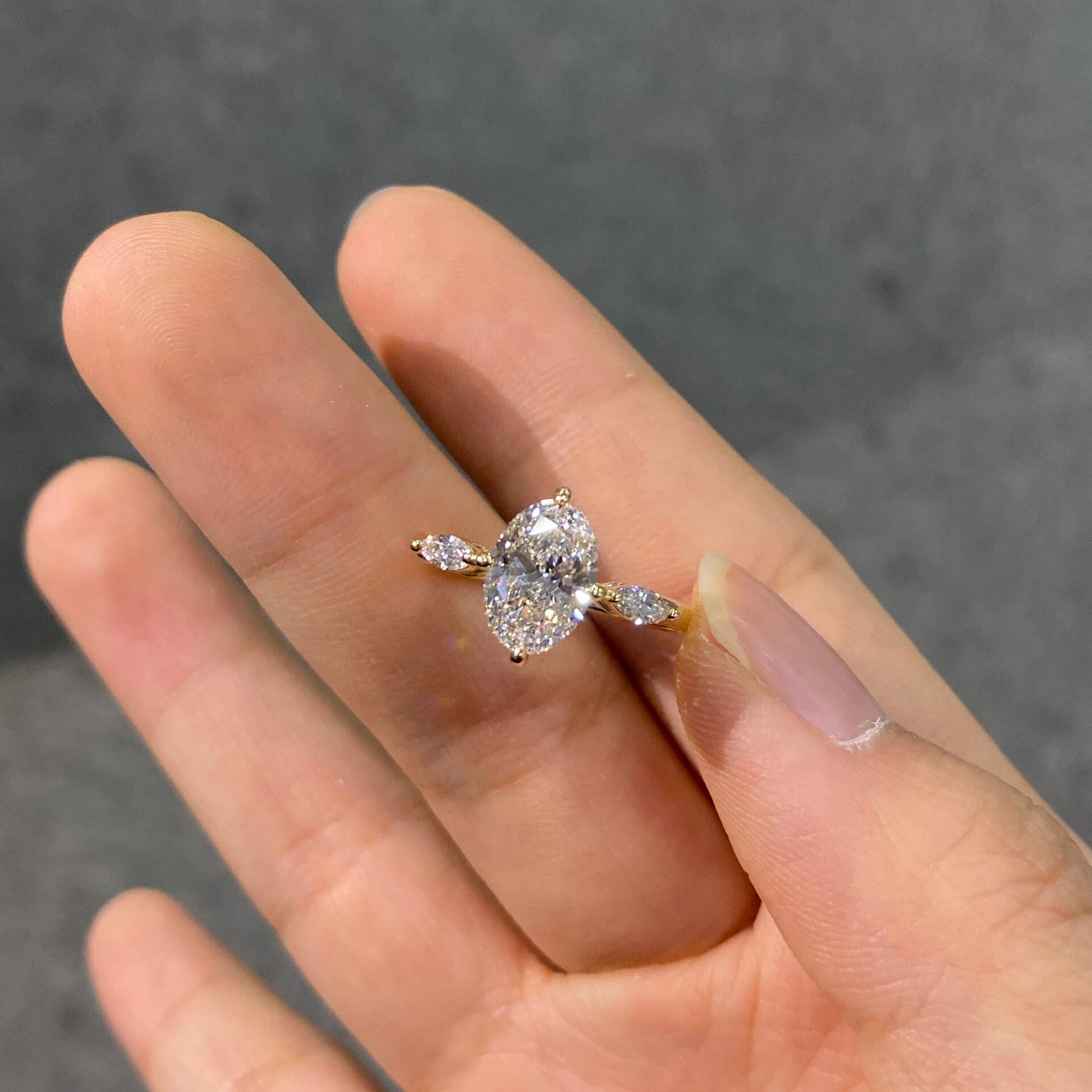 A unique three-stone diamond ring featuring an oval lab-grown diamond—dazzlingly brilliant, Color D, Clarity VS1