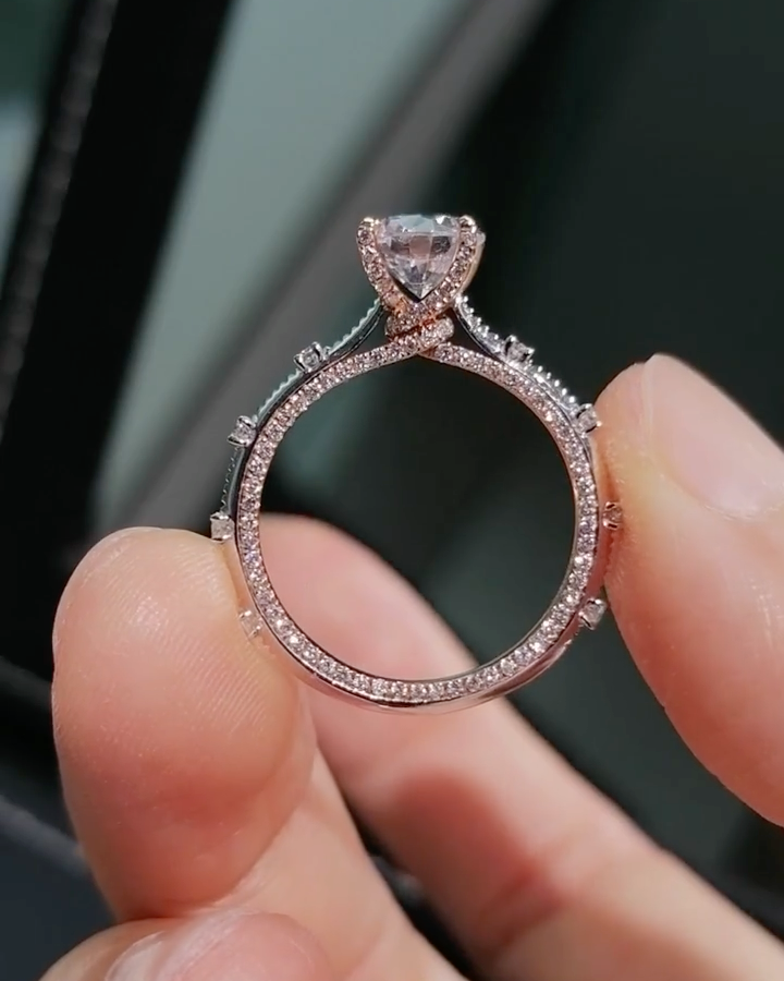 Two-tone band design with pavé-set diamonds; round lab-grown diamond in a four-prong setting, Color D, Clarity VS1.