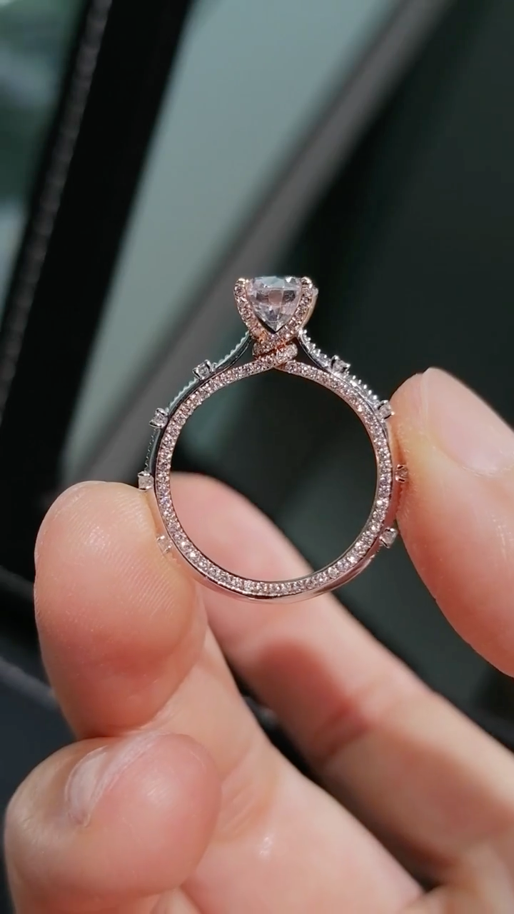 Two-tone band design with pavé-set diamonds; round lab-grown diamond in a four-prong setting, Color D, Clarity VS1.