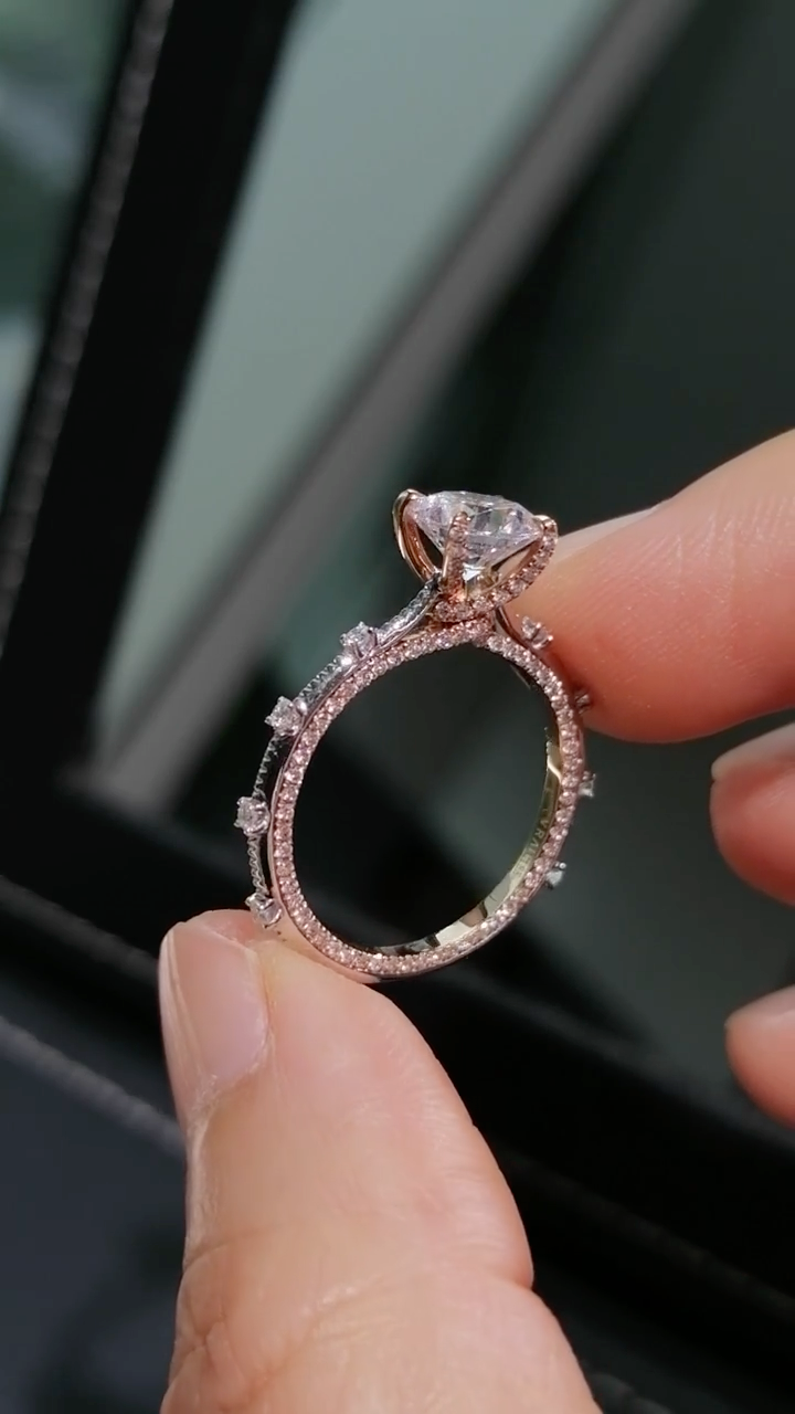 Two-tone band design with pavé-set diamonds; round lab-grown diamond in a four-prong setting, Color D, Clarity VS1.