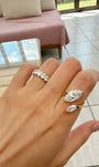 A dual-center-stone ring, set with marquise-cut lab-grown diamonds—radiant with shimmering brilliance and fluid grace, resting elegantly upon the fingertip