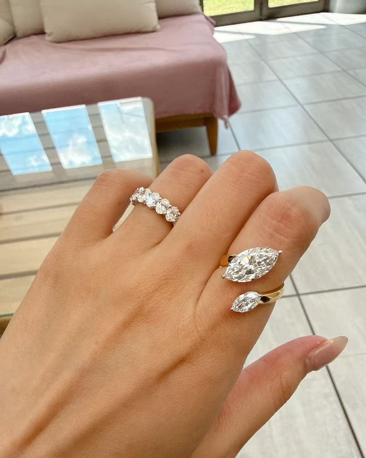 A dual-center-stone ring, set with marquise-cut lab-grown diamonds—radiant with shimmering brilliance and fluid grace, resting elegantly upon the fingertip