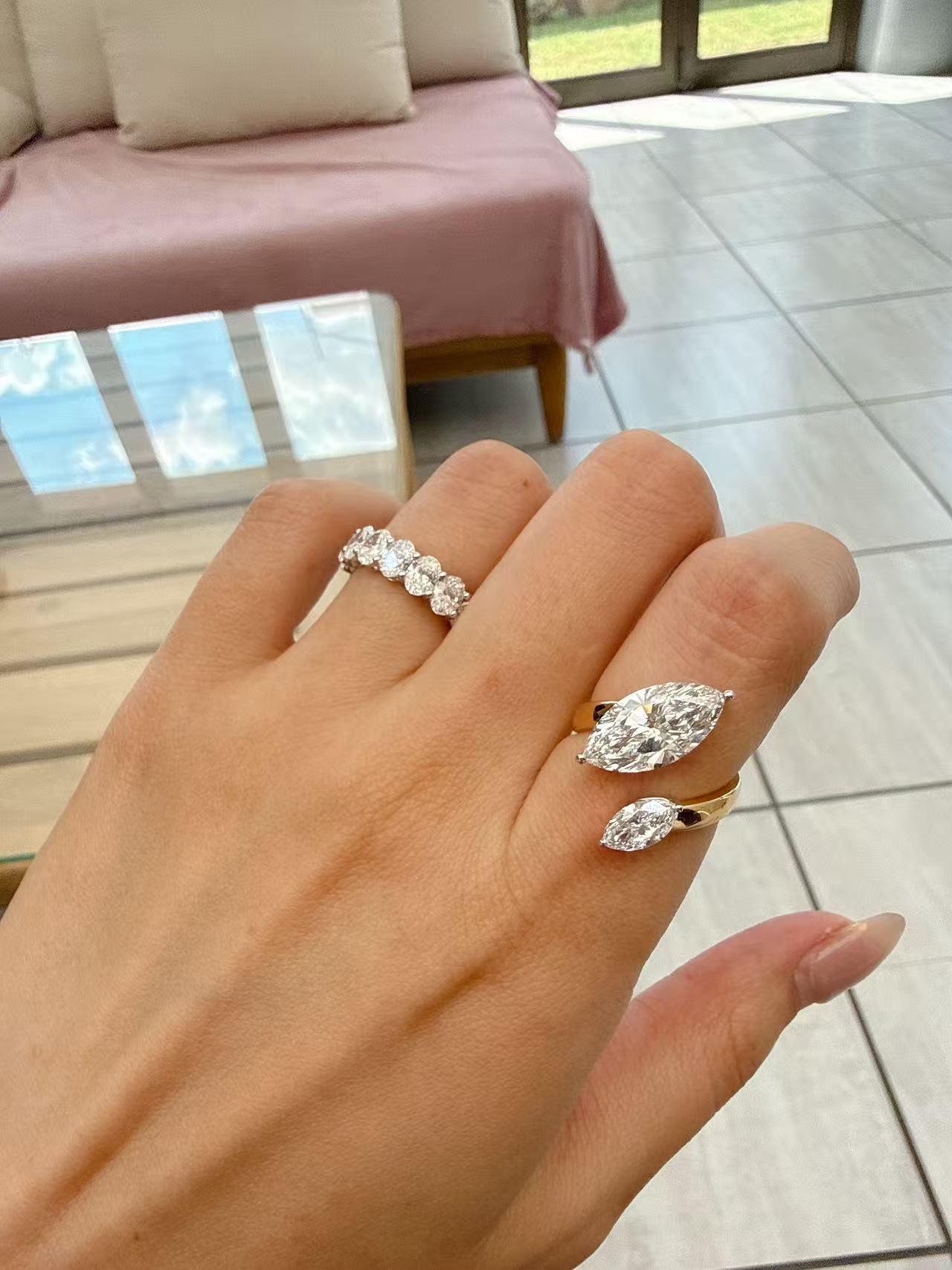 A dual-center-stone ring, set with marquise-cut lab-grown diamonds—radiant with shimmering brilliance and fluid grace, resting elegantly upon the fingertip